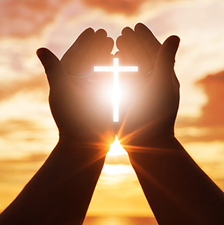 Hands holding light of Christ