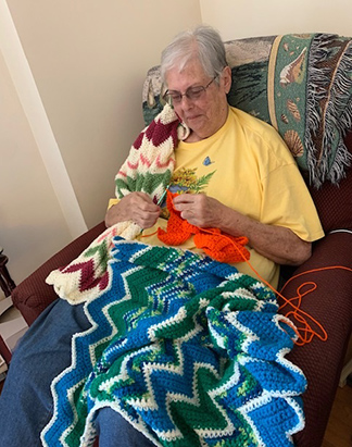 Sister Linda Giuli knits a blanket that will be sent to Rachel’s Gifts, 